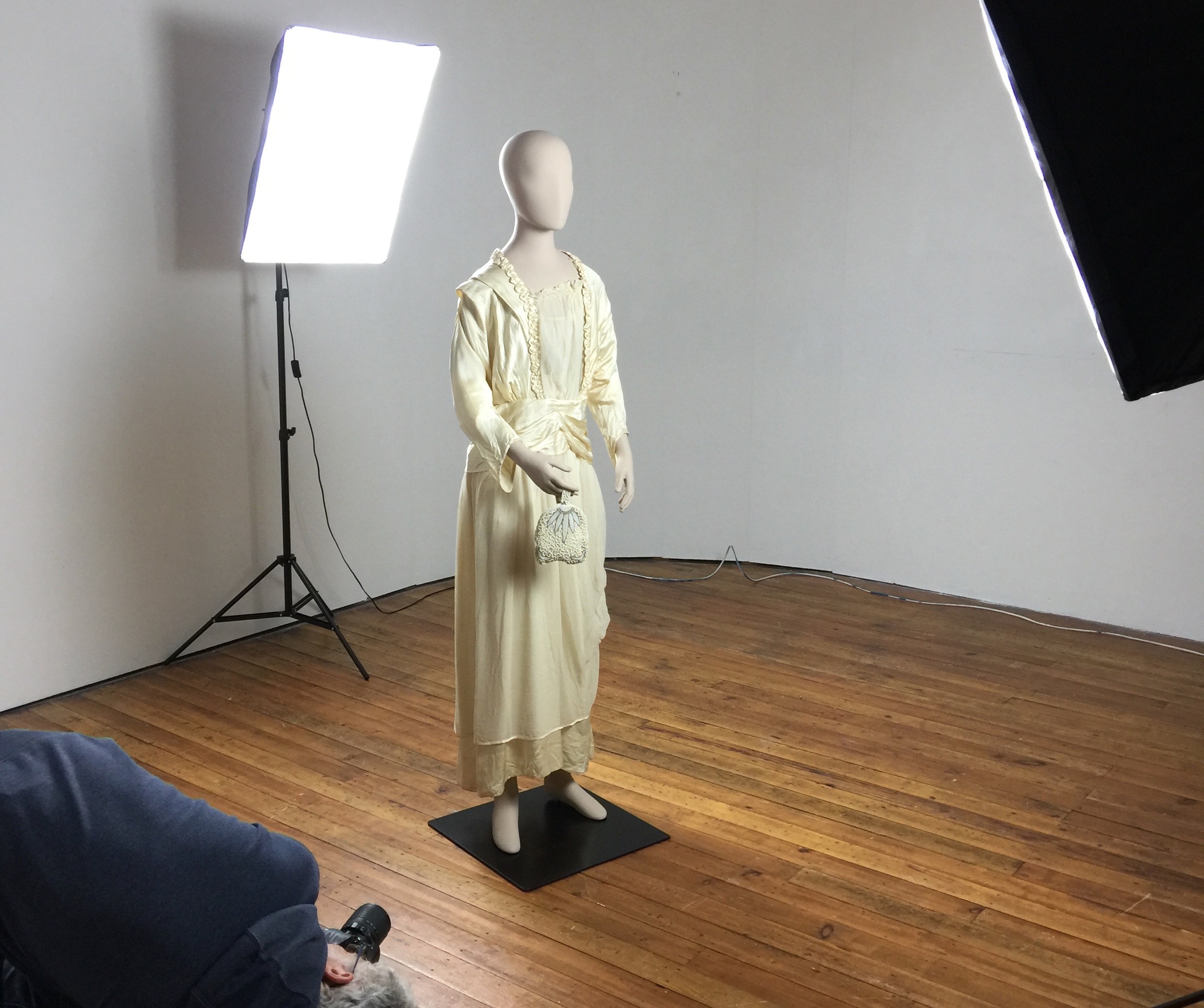 A volunteer photographs the dressed mannequin from every angle to ensure good coverage for photogrammetry